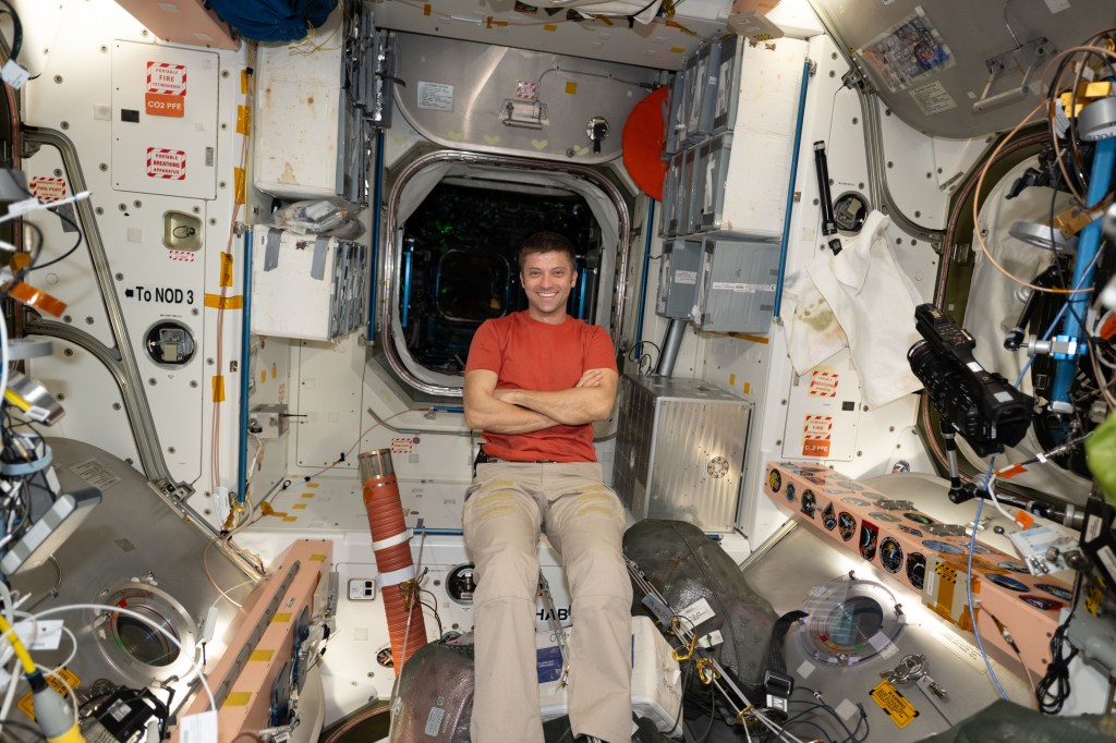 Expedition 70 Flight Engineer and NASA astronaut Matthew Dominick is pictured relaxing inside the International Space Station's Unity module during an orbital weekend.