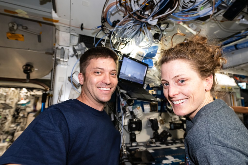 Expedition 70 Flight Engineers Matthew Dominick and Loral O'Hara, both NASA astronauts, smile for a portrait shortly after the SpaceX Dragon cargo craft docked to the International Space Station.