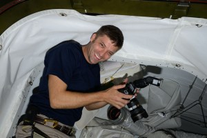 Expedition 70 Flight Engineer and NASA astronaut Matthew Dominick smiles for a portrait during photography duties aboard the International Space Station.