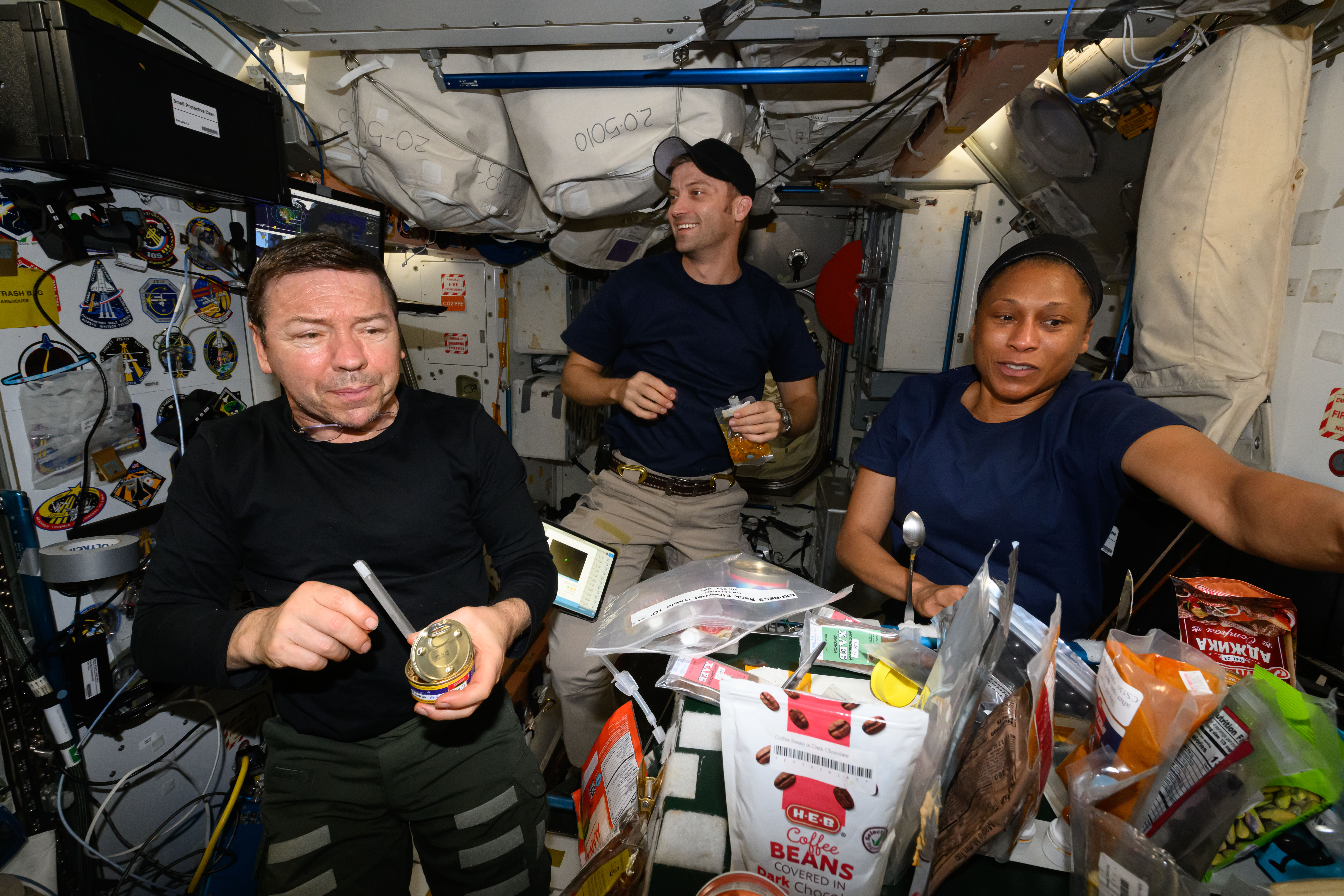 Expedition 70 Flight Engineers (from left) Mike Barratt, Matthew Dominick, and Jeanette Epps enjoy breakfast on a Sunday morning inside the International Space Station's Unity Module.