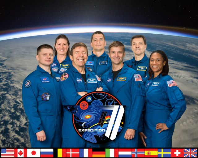 The official Expedition 71 crew portrait with (bottom row from left) Roscosmos cosmonaut Alexander Grebenkin and NASA astronauts Mike Barratt, Matthew Dominick, and Jeanette Epps. In the back row (from left) are, NASA astronaut Loral O'Hara and Roscosmos cosmonauts Nikolai Chub and Oleg Kononenko.