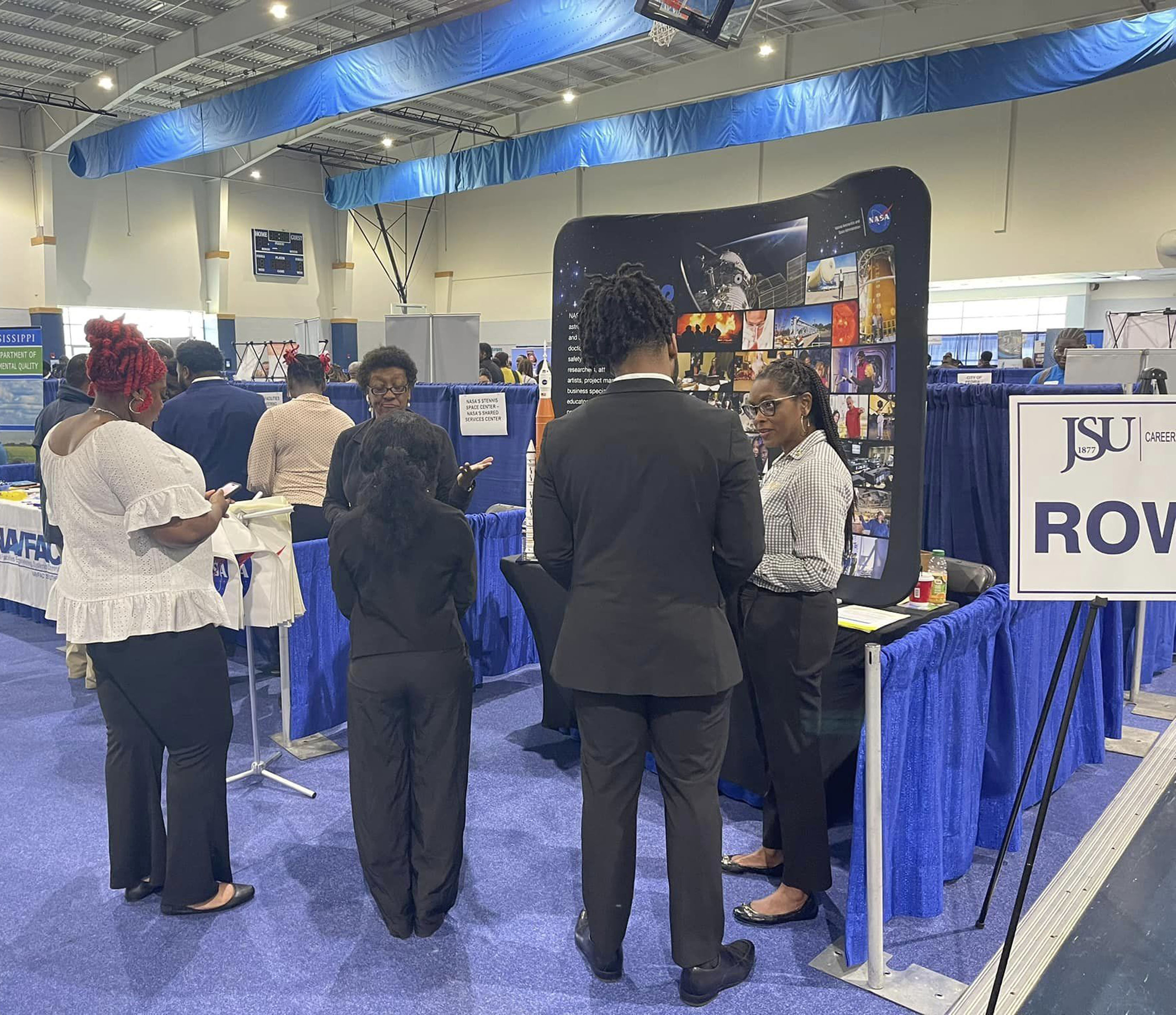 small crowd engages with NASA Stennis representative