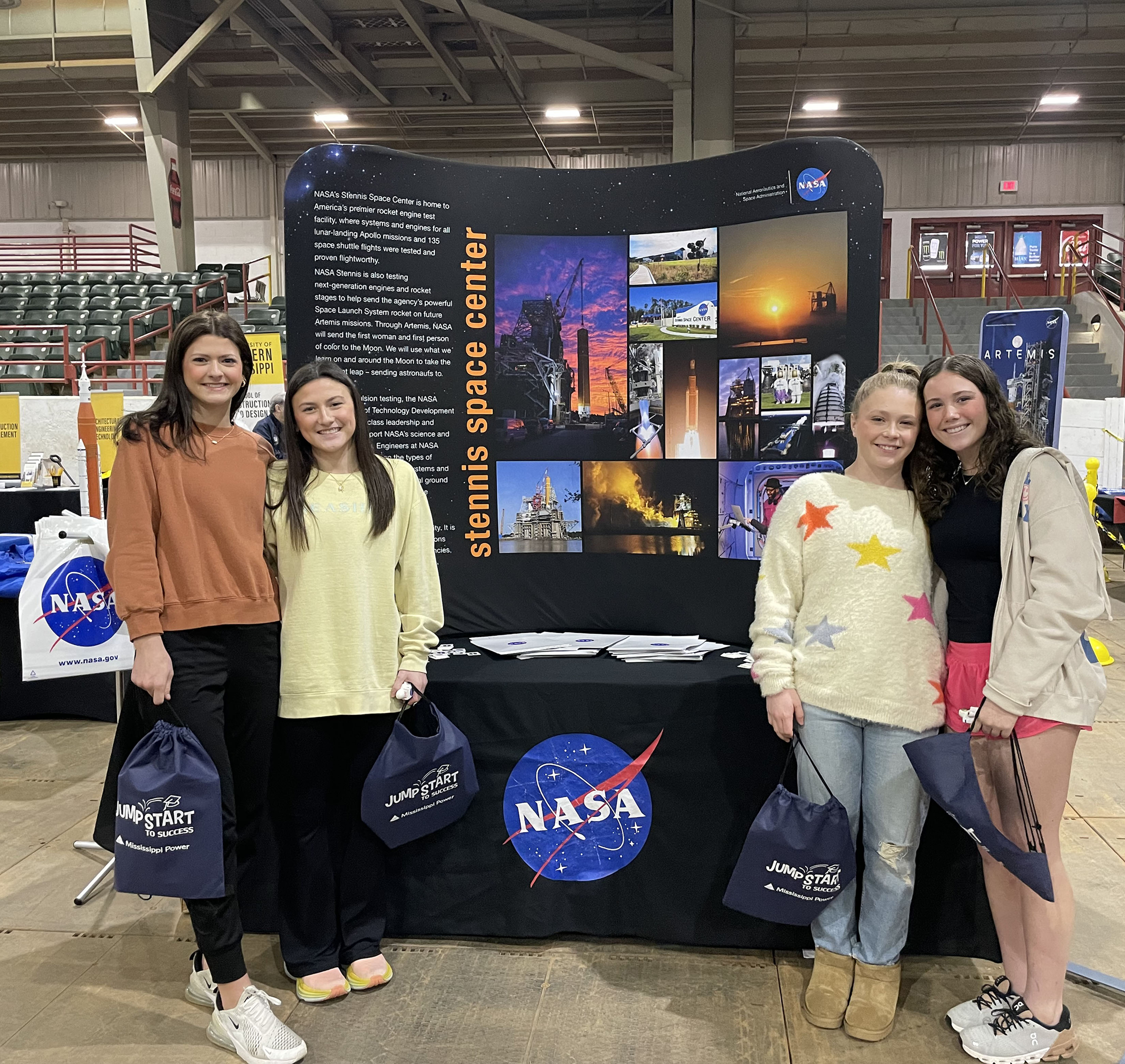 four students in front of exhibit at the Jumpstart to Success event