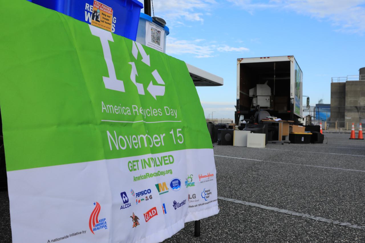 A sign tells NASA Kennedy Space Center employees they have come to the right place to donate items for reuse or recycling in conjunction with America Recycles Day. America Recycles Day is a nationally recognized initiative dedicated to promoting recycling in the United States. Kennedy partnered with several organizations in order to donate as many of the items as possible to those who could use them the most in the Space Coast community. Space center personnel brought in electronic waste, gently used household goods, clothing and more. The two-day event was sponsored by Kennedy's Sustainability team.