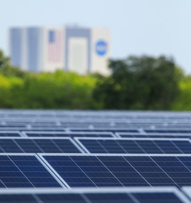 Seen here, with the iconic Vehicle Assembly Building in the background, is an up-close view of solar panels that are part of Florida Power and Light’s (FPL) new Discovery Solar Energy Center at NASA’s Kennedy Space Center in Florida. The 74.5-megawatt solar site spans 491 acres at Kennedy and contains about 250,000 solar panels. Harnessing energy from the Sun, the panels produce enough energy to power approximately 15,000 homes. The panels do not directly power anything at Kennedy, and instead, send energy directly to FPL’s electricity grid for distribution to existing customers. Construction began in spring 2020, and the energy center became fully operational on May 30, 2021.