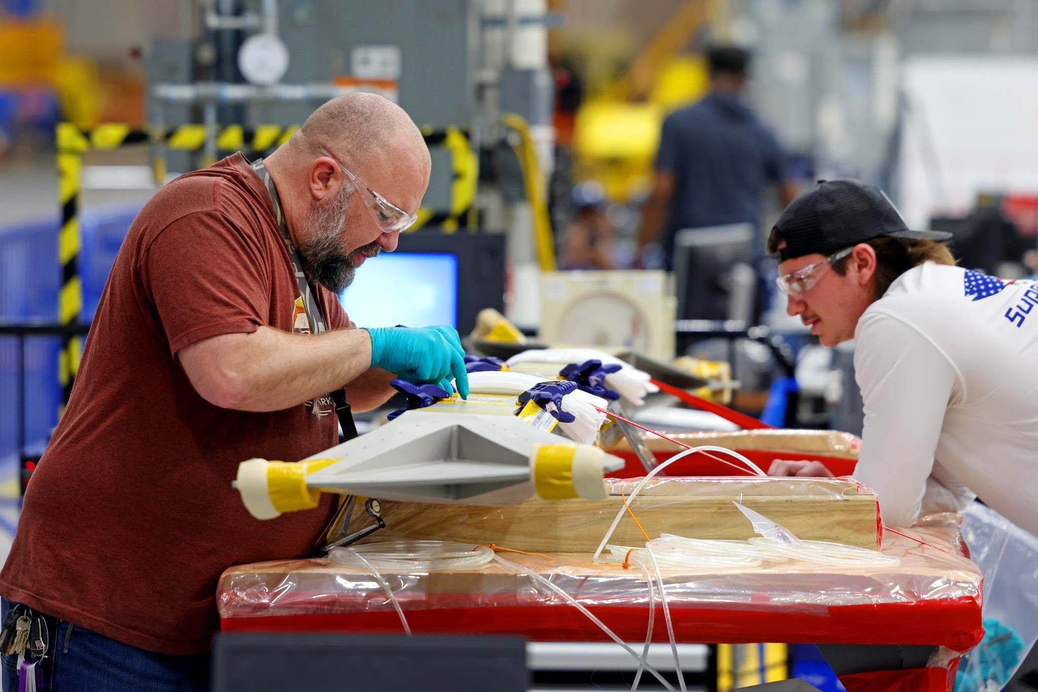 : Technicians at NASA's Michoud Assembly Facility in New Orleans on Feb. 22 prepare elements that will form part of the midbody for the exploration upper stage. The midbody struts, or V-struts, will create the cage-like outer structure of the midbody that will connect the upper stage's large liquid hydrogen tank to the smaller liquid oxygen tank. Manufacturing flight and test hardware for the future upper stage is a collaborative effort between NASA and Boeing, the lead contractor for EUS and the SLS core stage.