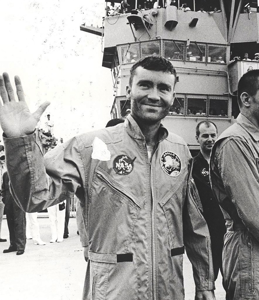 Man waving on ship deck.