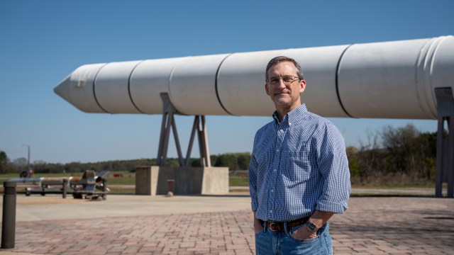 Mat Bevill, the associate chief engineer for NASA’s SLS (Space Launch System) Program, stands in front of a four-segment solid rocket booster that powered the space shuttle at NASA’s Marshall Space Flight Center in Huntsville, Alabama.