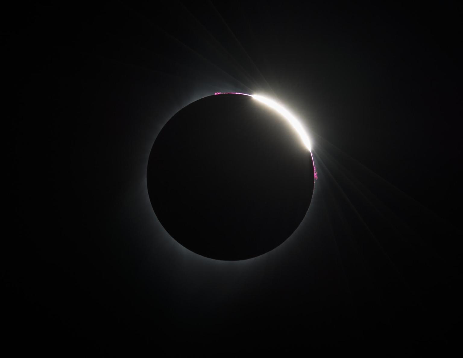 Some prominences are seen as the moon begins to move off the sun during the total solar eclipse on Monday, August 21, 2017 above Madras, Oregon.