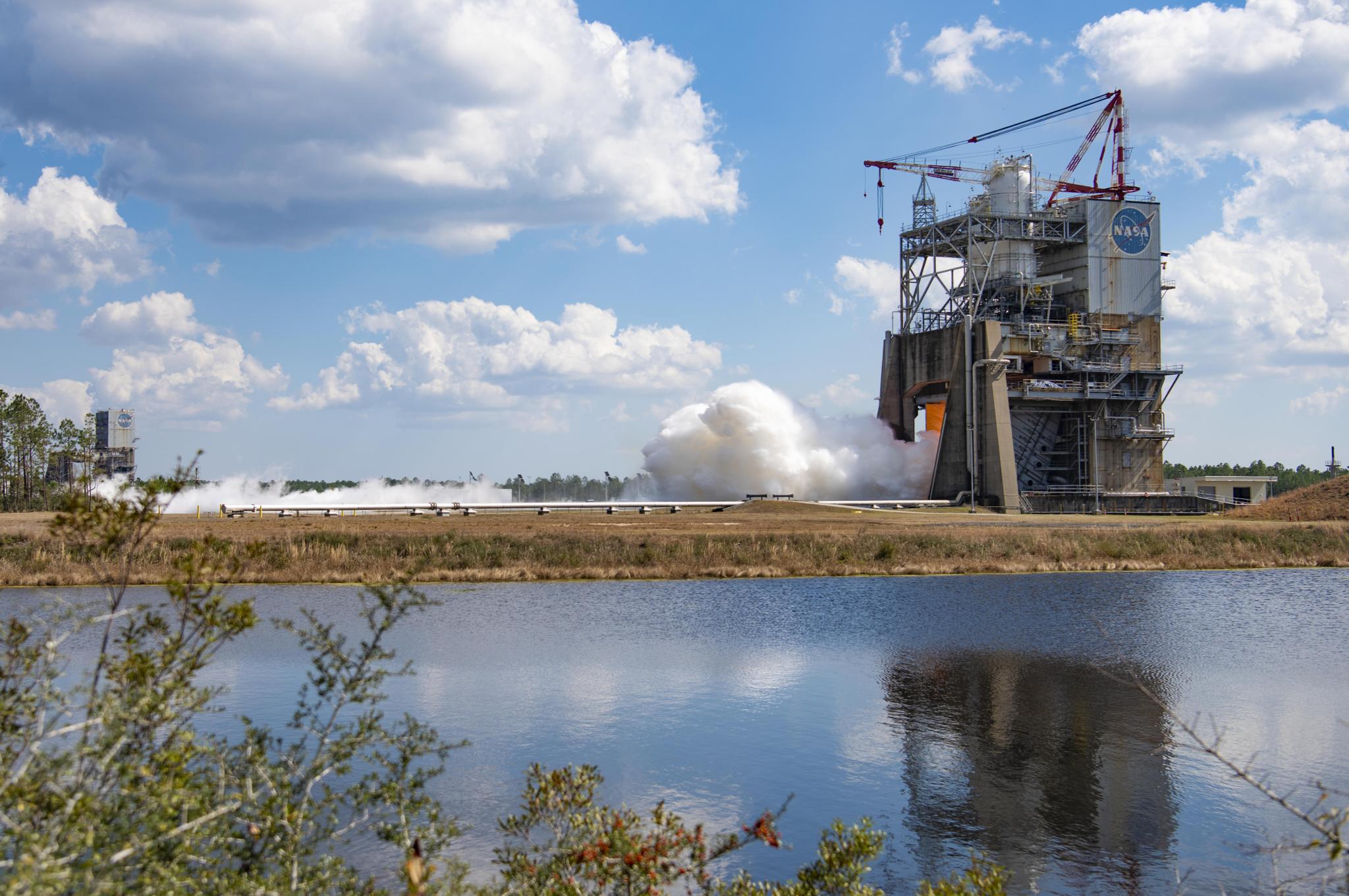 view of a RS-25 hot fire from across the water