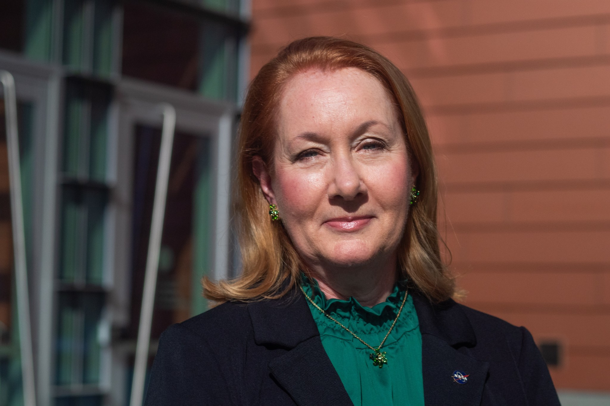 Lisa Ziehmann is the Acting Deputy Center Director at NASA Langley Research Center. She is pictured in this photo smiling and wearing a green shirt and black balzer.