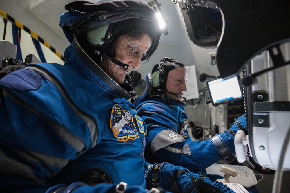 NASA astronauts Sunita L. Williams, left, and Barry “Butch” E. Wilmore suited up for a training session in the Boeing Starliner simulator