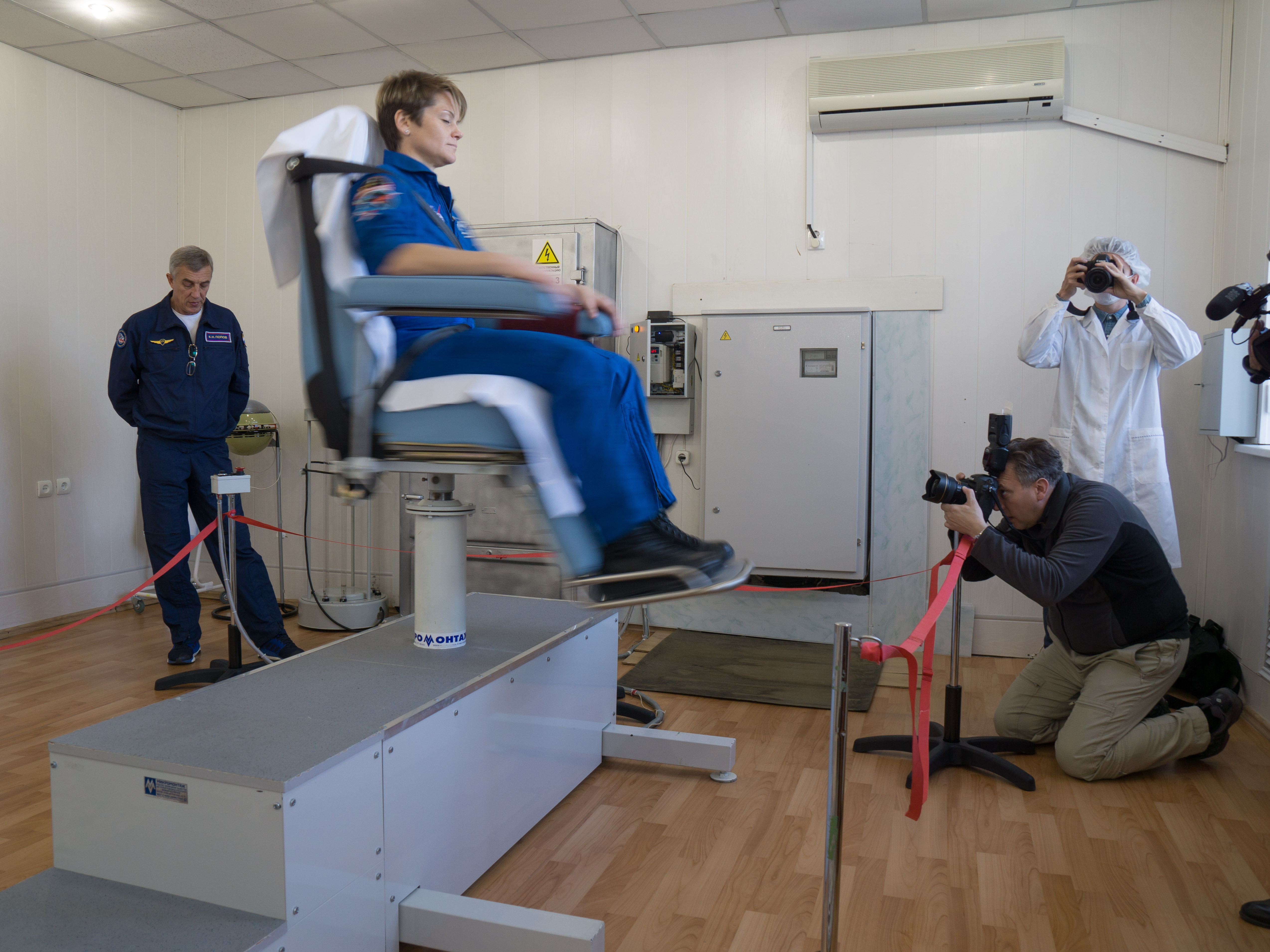 jsc2018e097775 - At the Cosmonaut Hotel crew quarters in Baikonur, Kazakhstan, Expedition 58 crew member Anne McClain of NASA conducts vestibular system response training in a spinning chair Nov. 27 as part of pre-launch training. McClain, David Saint-Jacques of the Canadian Space Agency and Oleg Kononenko of Roscosmos will launch Dec. 3 on the Soyuz MS-11 spacecraft from the Baikonur Cosmodrome in Kazakhstan for a six-and-a-half month mission on the International Space Station...NASA/Victor Zelentsov
