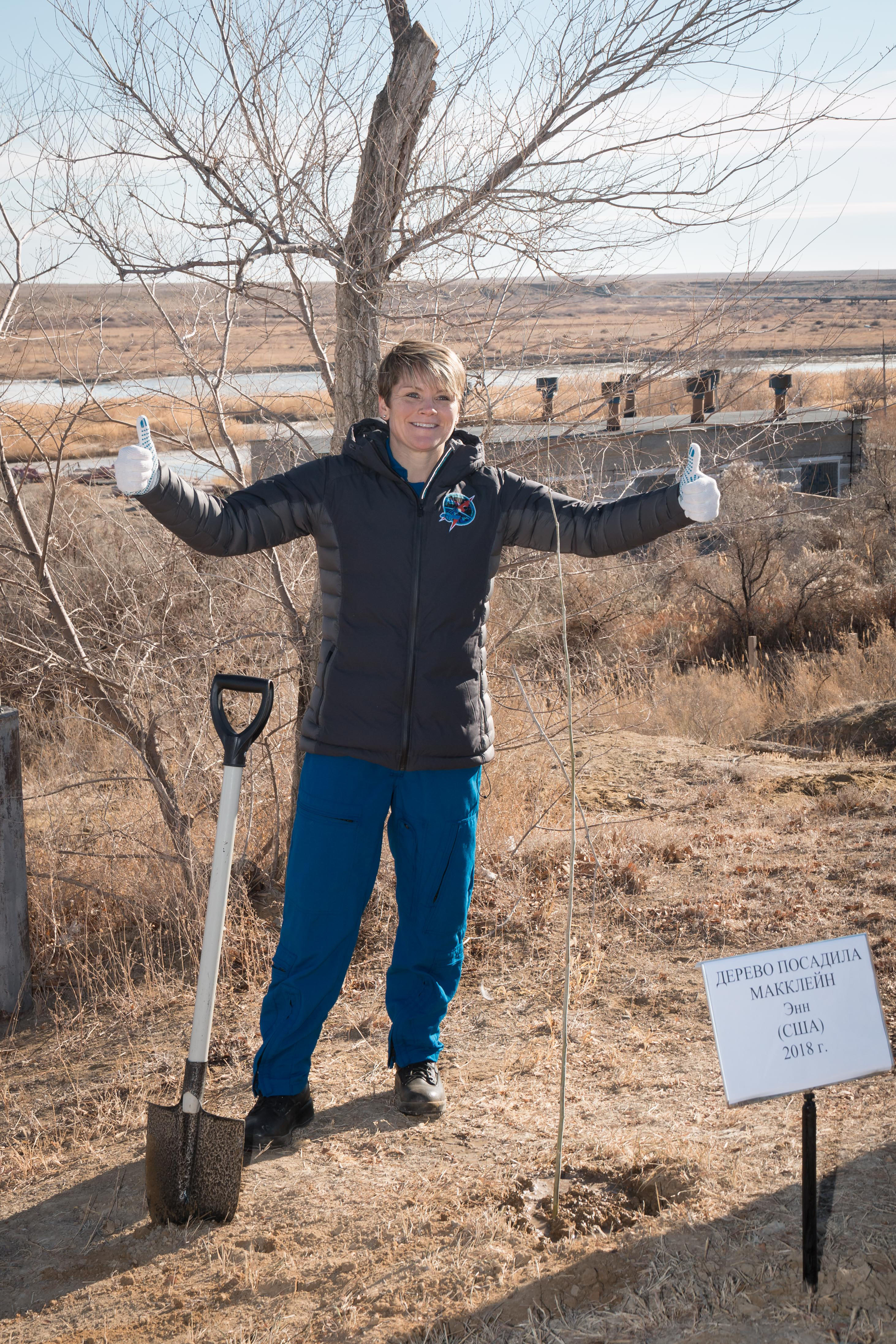 jsc2018e097779 - At the Cosmonaut Hotel crew quarters in Baikonur, Kazakhstan, Expedition 58 crew member Anne McClain of NASA poses for pictures Nov. 27 after planting a tree in her name in traditional pre-launch activities. McClain, David Saint-Jacques of the Canadian Space Agency and Oleg Kononenko of Roscosmos will launch Dec. 3 on the Soyuz MS-11 spacecraft from the Baikonur Cosmodrome in Kazakhstan for a six-and-a-half month mission on the International Space Station...NASA/Victor Zelentsov