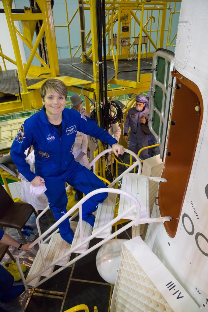 jsc2018e098090 - In the Integration Facility at the Baikonur Cosmodrome in Kazakhstan, Expedition 58 crew member Anne McClain of NASA prepares to climb aboard the Soyuz MS-11 spacecraft Nov. 29 during a final vehicle fit check. McClain, Oleg Kononenko of Roscosmos and David Saint-Jacques of the Canadian Space Agency will launch Dec. 3 in the Soyuz MS-11 spacecraft from the Baikonur Cosmodrome in Kazakhstan for a six-and-a-half month mission on the International Space Station...NASA/Victor Zelentsov