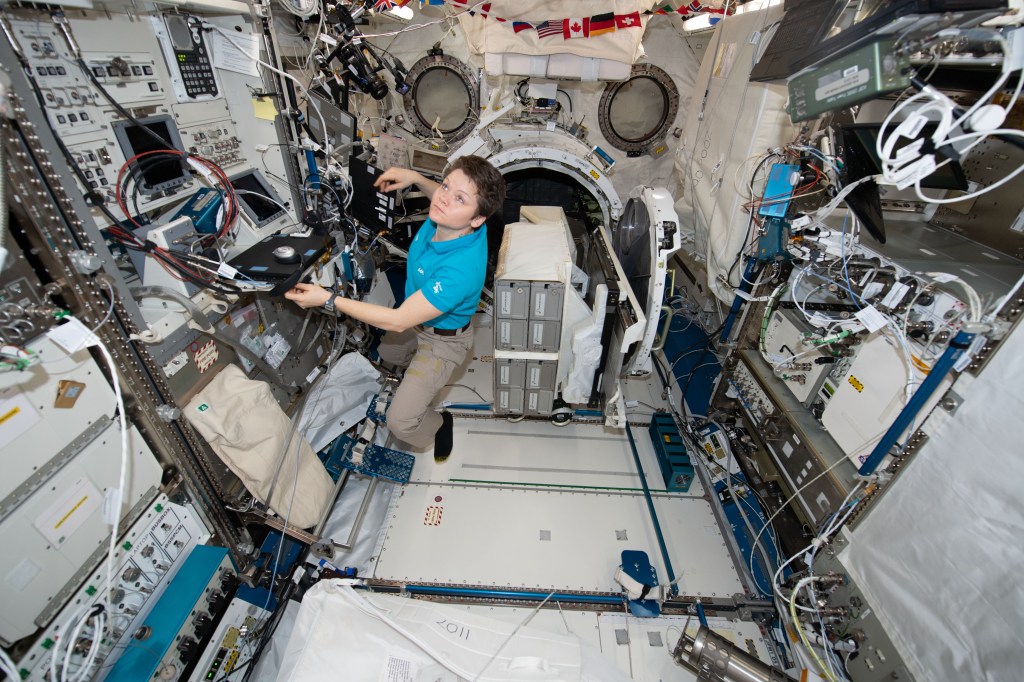 iss058e007642 (Jan. 30, 2019) --- NASA astronaut Anne McClain works inside the Kibo laboratory module designed and built by the Japan Aerospace Exploration Agency. McClain is working to install the NanoRacks CubeSat Deployer in Kibo's airlock.