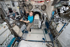 iss058e007642 (Jan. 30, 2019) --- NASA astronaut Anne McClain works inside the Kibo laboratory module designed and built by the Japan Aerospace Exploration Agency. McClain is working to install the NanoRacks CubeSat Deployer in Kibo's airlock.