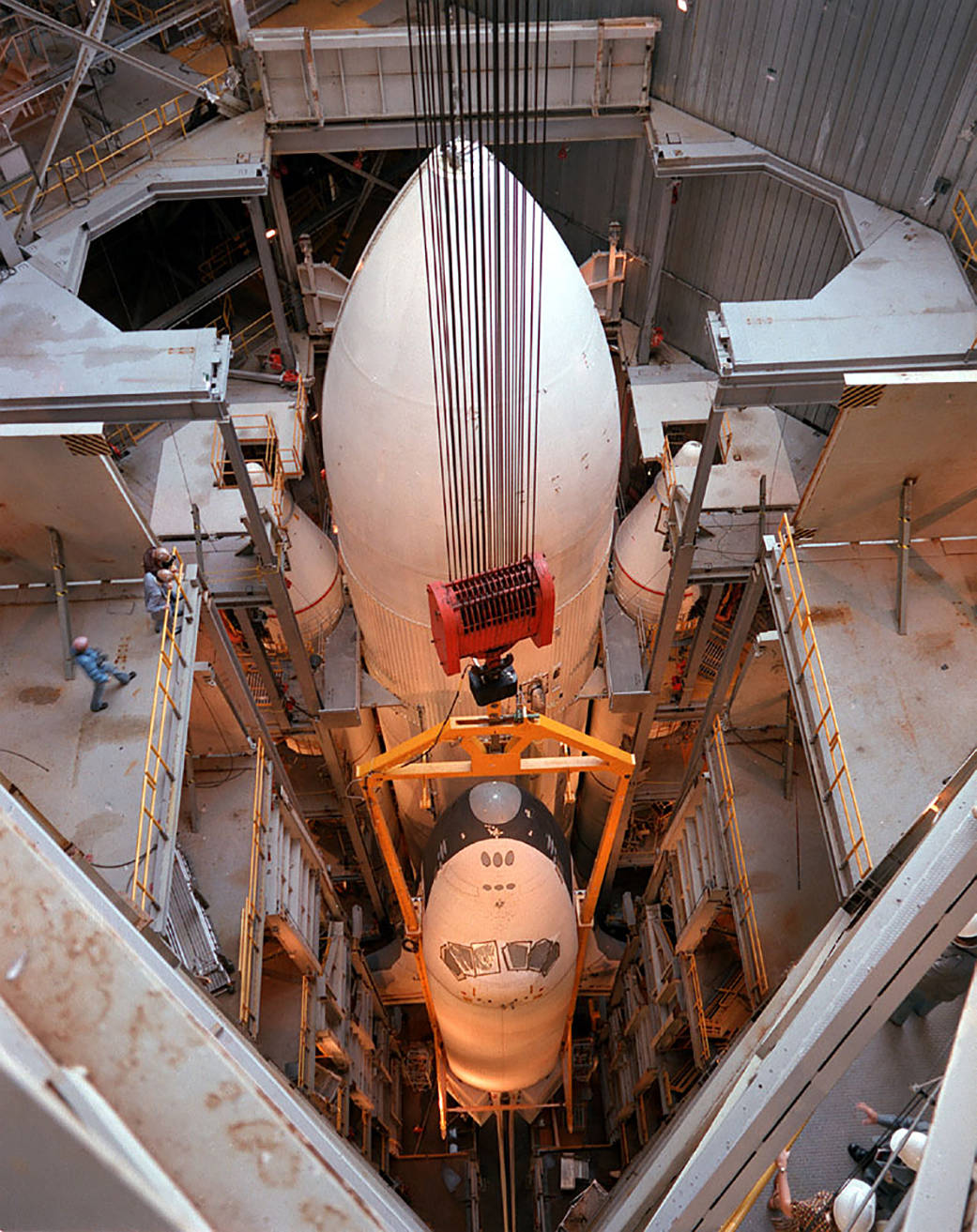 At NASA’s Marshall Space Flight Center in Huntsville, Alabama, for vibration tests, a shuttle orbiter joins an External Tank and twin Solid Rocket Boosters for the first time