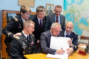 jsc2018e096935 (Nov. 15, 2018) --- At the Gagarin Museum at the Gagarin Cosmonaut Training Center in Star City, Russia, Expedition 58 backup crew members Drew Morgan of NASA (front row, left), Alexander Skvortsov of Roscosmos (front row, center) and Luca Parmitano of the European Space Agency (front row, right) sign a book bearing crews’ signatures in a traditional ceremony Nov. 15. Looking on in the back row are the prime crew members, Anne McClain of NASA (left), Oleg Kononenko of Roscosmos (center) and David Saint-Jacques of the Canadian Space Agency (right), who will launch Dec. 3 on the Soyuz MS-11 spacecraft from the Baikonur Cosmodrome in Kazakhstan for a six-and-a-half month mission on the International Space Station...NASA/Sarah Volkman