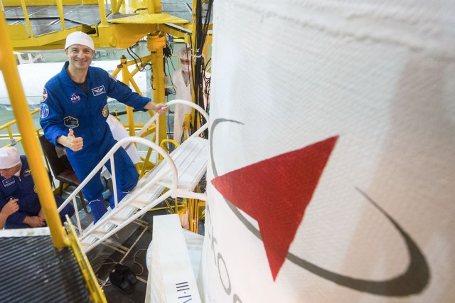 jsc2019e039434 (July 16, 2019) --- At the Baikonur Cosmodrome in Kazakhstan, Expedition 60 crewmember Drew Morgan of NASA flashes a thumbs up July 16 as he boards the Soyuz MS-13 spacecraft for a final fit check as part of pre-launch preparations. Morgan, Alexander Skvortsov of Roscosmos and Luca Parmitano of the European Space Agency will launch July 20 on the Soyuz MS-13 spacecraft from the Baikonur Cosmodrome for a mission on the International Space Station. Credit: Andrey Shelepin/GCTC