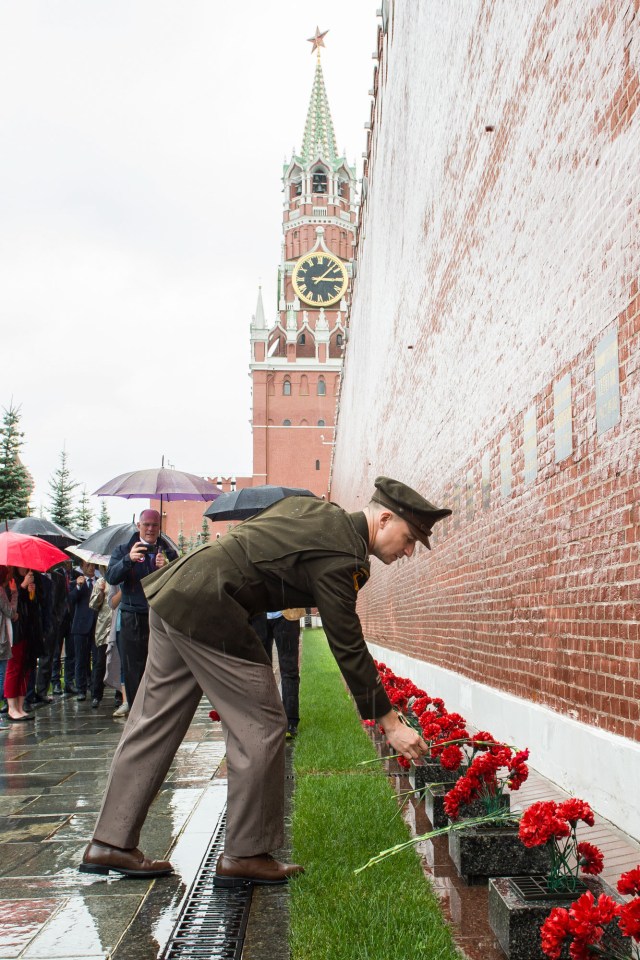 jsc2019e036812 (June 28, 2019) --- At Red Square in Moscow, Expedition 60 crewmember Drew Morgan of NASA lays flowers at the Kremlin Wall June 28 where Russian space icons are interred in traditional pre-launch activities. Morgan, Luca Parmitano of the European Space Agency and Alexander Skvortsov of Roscosmos will launch July 20 on the Soyuz MS-13 spacecraft from the Baikonur Cosmodrome in Kazakhstan for a mission on the International Space Station. Credit: Andrey Shelepin/GCTC