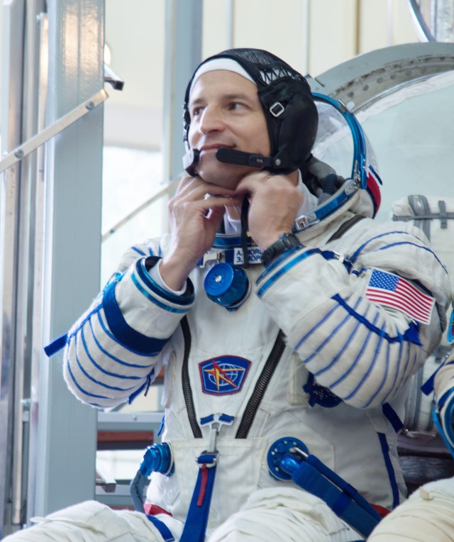 jsc2019e035393 (June 27, 2019) --- At the Gagarin Cosmonaut Training Center in Star City, Russia, Expedition 60 crewmember Drew Morgan of NASA adjusts his helmet June 27 as he listens to a reporter’s question during the final day of qualification exams. Morgan, Alexander Skvortsov of Roscosmos and Luca Parmitano of the European Space Agency will launch on July 20 from the Baikonur Cosmodrome in Kazakhstan on the Soyuz MS-13 spacecraft for a mission to the International Space Station...NASA/Beth Weissinger