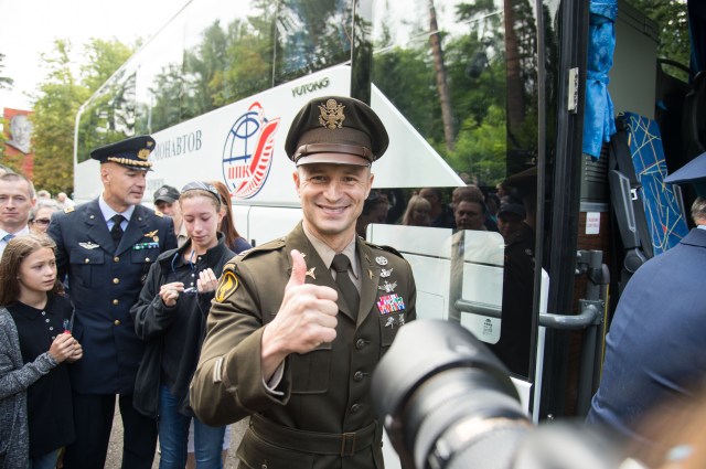 jsc2019e038377 (July 4, 2019) --- At the Gagarin Cosmonaut Training Center in Star City, Russia, Expedition 60 crewmember Drew Morgan of NASA flashes a thumbs up as he boards a bus July 4 before departing on a flight for his launch site in Kazakhstan. In the background is crewmate Luca Parmitano of the European Space Agency. Morgan, Parmitano and Alexander Skvortsov of Roscosmos will launch July 20 from the Baikonur Cosmodrome in Kazakhstan on the Soyuz MS-13 spacecraft for a mission on the International Space Station. Credit: NASA/Beth Weissinger
