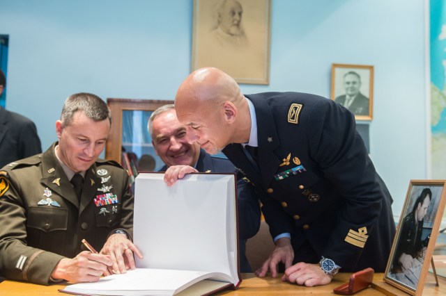 jsc2019e036813 (June 28, 2019) --- At the Gagarin Cosmonaut Training Center in Star City, Russia, Expedition 60 crewmember Drew Morgan of NASA (left) signs a ceremonial book June 28 during pre-launch activities. Looking on are crewmates Alexander Skvortsov of Roscosmos (center) and Luca Parmitano of the European Space Agency (right). Morgan, Parmitano and Skvortsov will launch July 20 on the Soyuz MS-13 spacecraft from the Baikonur Cosmodrome in Kazakhstan for a mission on the International Space Station. Credit: Andrey Shelepin/GCTC