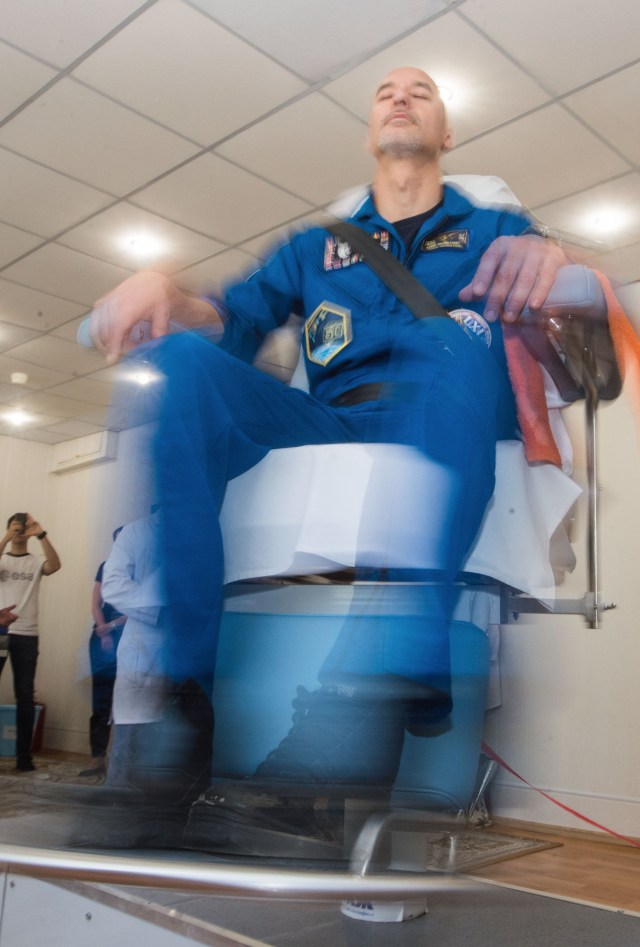jsc2019e039267 (July 12, 2019) --- At the Cosmonaut Hotel crew quarters in Baikonur, Kazakhstan, Expedition 60 crewmember Luca Parmitano of the European Space Agency takes a ride in a spinning chair July 12 to test his vestibular system as part of pre-launch activities. Parmitano, Drew Morgan of NASA and Alexander Skvortsov of Roscosmos will launch July 20 on the Soyuz MS-13 spacecraft from the Baikonur Cosmodrome in Kazakhstan on a mission to the International Space Station. Credit: Andrey Shelepin/GCTC