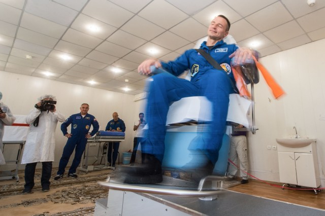jsc2019e039262 (July 12, 2019) --- At the Cosmonaut Hotel crew quarters in Baikonur, Kazakhstan, Expedition 60 crewmember Drew Morgan of NASA takes a ride in a spinning chair July 12 to test his vestibular system as part of pre-launch activities. Morgan, Alexander Skvortsov of Roscosmos and Luca Parmitano of the European Space Agency will launch July 20 on the Soyuz MS-13 spacecraft from the Baikonur Cosmodrome in Kazakhstan on a mission to the International Space Station. Credit: Andrey Shelepin/GCTC