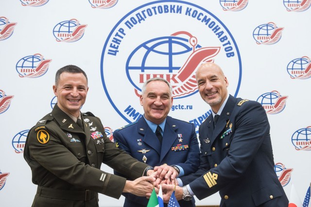 jsc2019e036809 (June 28, 2019) --- At the Gagarin Cosmonaut Training Center in Star City, Russia, Expedition 60 crewmembers Drew Morgan of NASA (left), Alexander Skvortsov of Roscosmos (center) and Luca Parmitano of the European Space Agency (right) pose for pictures June 28 during a news conference. They will launch July 20 on the Soyuz MS-13 spacecraft from the Baikonur Cosmodrome in Kazakhstan for a mission on the International Space Station. Credit: Andrey Shelepin/GCTC