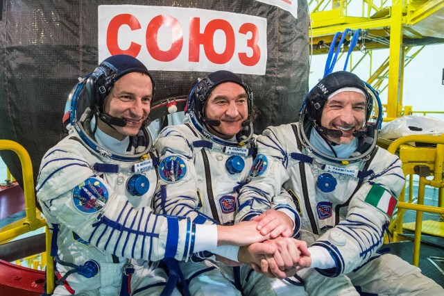 jsc2019e038381 (July 5, 2019) --- At the Baikonur Cosmodrome in Kazakhstan, Expedition 60 crewmembers Drew Morgan of NASA (left), Alexander Skvortsov of Roscosmos (center) and Luca Parmitano of the European Space Agency (right) pose for pictures July 5 in front of their Soyuz spacecraft during pre-launch preparations. They will launch July 20 on the Soyuz MS-13 spacecraft from the Baikonur Cosmodrome for a mission on the International Space Station. Credit: Andrey Shelepin/GCTC