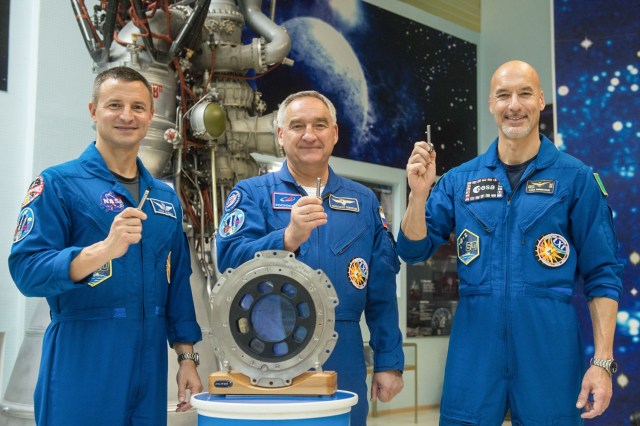 jsc2019e039430 (July 16, 2019) --- At the Baikonur Cosmodrome in Kazakhstan, Expedition 60 crewmembers Drew Morgan of NASA (left), Alexander Skvortsov of Roscosmos (center) and Luca Parmitano of the European Space Agency pose for pictures July 16 holding replicas of launch keys used to initiate a Soyuz rocket’s liftoff. They will launch July 20 on the Soyuz MS-13 spacecraft from the Baikonur Cosmodrome for a mission on the International Space Station. Credit: Andrey Shelepin/GCTC