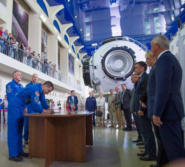 jsc2019e035255 (June 26, 2019) --- At the Gagarin Cosmonaut Training Center in Star City, Russia, Expedition 60 crewmember Drew Morgan of NASA signs in June 26 for the first day of final qualification exams. Looking on are crewmates Alexander Skvortsov of Roscosmos and Luca Parmitano of the European Space Agency. They will launch July 20 on the Soyuz MS-13 spacecraft from the Baikonur Cosmodrome in Kazakhstan for a mission on the International Space Station. Credit: NASA/Beth Weissinger