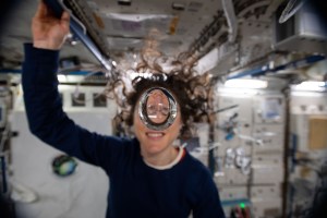 iss060e001486 (July 29, 2019) --- Expedition 60 Flight Engineer Christina Koch of NASA playfully demonstrates how fluids behave in the weightless environment of microgravity aboard the International Space Station.