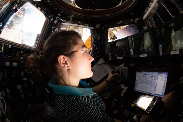 iss060e013324 (July 18, 2019) --- Expedition 60 Flight Engineer Christina Koch of NASA trains on the robotics workstation inside the International Space Station's "window to the world," the seven-windowed Cupola. She and NASA astronaut Nick Hague will be in the cupola to command the Canadarm2 robotic arm to capture the next SpaceX Dragon cargo craft.