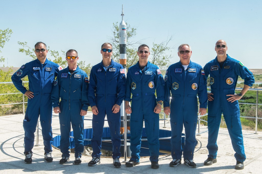 jsc2019e039272 (July 12, 2019) --- At the Cosmonaut Hotel crew quarters in Baikonur, Kazakhstan, the Expedition 60 prime and backup crewmembers pose for pictures July 12 as part of pre-launch activities. From left to right are backup crewmembers Soichi Noguchi of the Japan Aerospace Exploration Agency, Sergey Ryzhikov of Roscosmos and Tom Marshburn of NASA and prime crewmembers Drew Morgan of NASA, Alexander Skvortsov of Roscosmos and Luca Parmitano of the European Space Agency. Morgan, Skvortsov and Parmitano will launch July 20 on the Soyuz MS-13 spacecraft from the Baikonur Cosmodrome in Kazakhstan on a mission to the International Space Station. Credit: Andrey Shelepin/GCTC