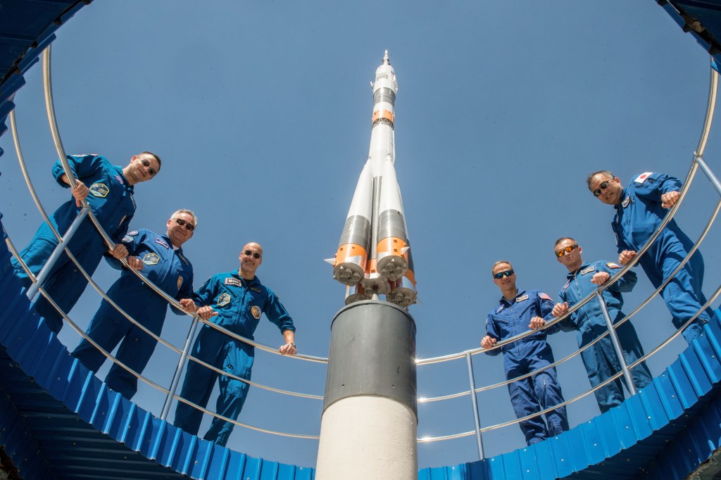 jsc2019e039264 (July 12, 2019) --- At the Cosmonaut Hotel crew quarters in Baikonur, Kazakhstan, the Expedition 60 prime and backup crewmembers pose for pictures July 12 as part of pre-launch activities. From left to right are prime crewmembers Drew Morgan of NASA, Alexander Skvortsov of Roscosmos and Luca Parmitano of the European Space Agency and backup crewmembers Tom Marshburn of NASA, Sergey Ryzhikov of Roscosmos and Soichi Noguchi of the Japan Aerospace Exploration Agency. Morgan, Skvortsov and Parmitano will launch July 20 on the Soyuz MS-13 spacecraft from the Baikonur Cosmodrome in Kazakhstan on a mission to the International Space Station. Credit: Andrey Shelepin/GCTC