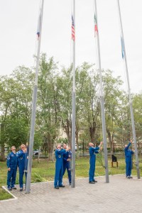 jsc2019e038396 (July 6, 2019) --- At their Cosmonaut Hotel crew quarters in Baikonur, Kazakhstan, Expedition 60 prime and backup crewmembers Sergey Ryzhikov and Alexander Skvortsov of Roscosmos, Drew Morgan and Tom Marshburn of NASA, Luca Parmitano of the European Space Agency and Soichi Noguchi of the Japan Aerospace Exploration Space Agency raise the flags of Russia, the United States, Italy and Kazakhstan in a traditional ceremony July 6. Morgan, Parmitano and Skvortsov will launch July 20 on the Soyuz MS-13 spacecraft from the Baikonur Cosmodrome in Kazakhstan for a mission on the International Space Station. Credit: Andrey Shelepin/GCTC