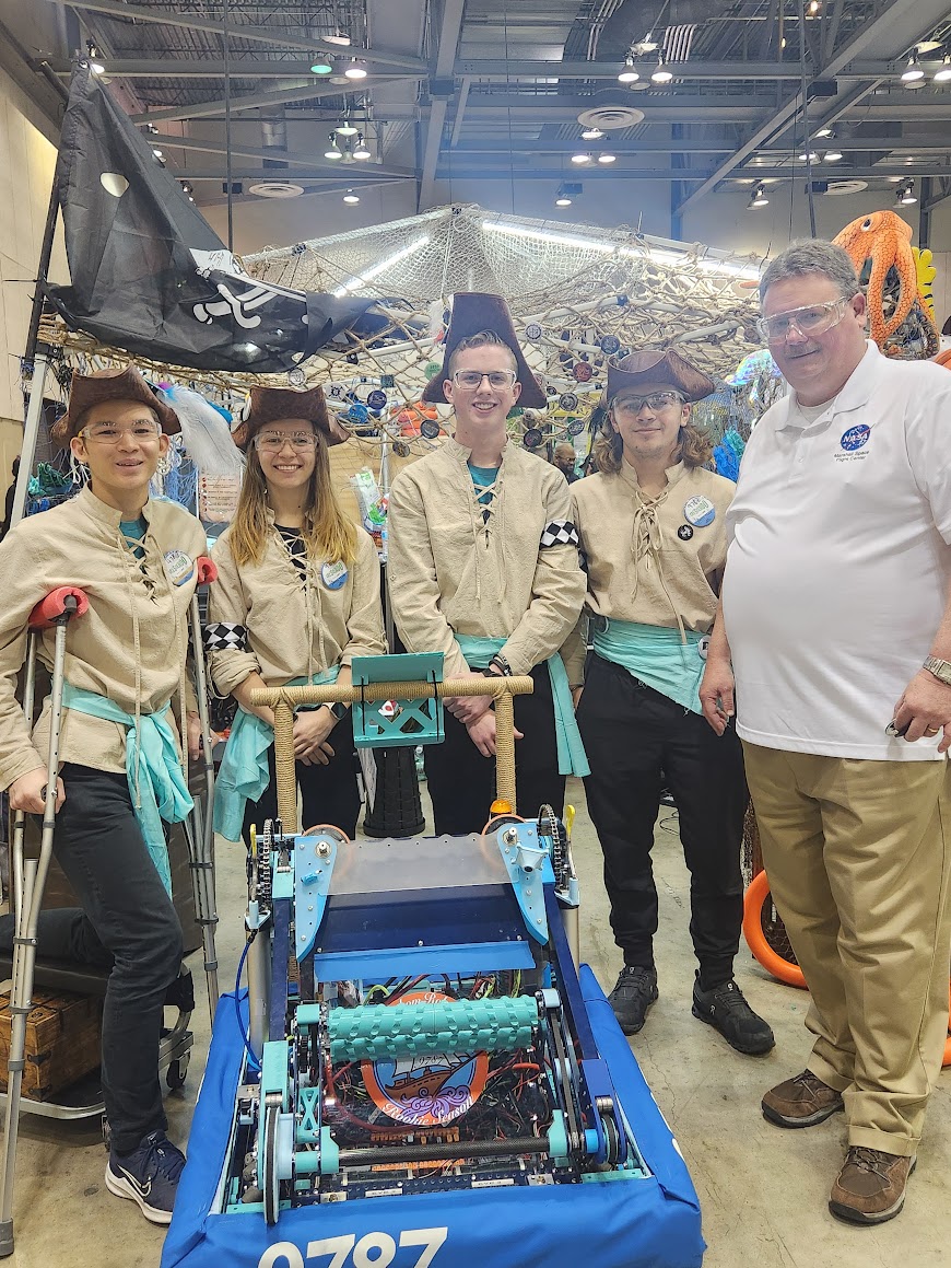 Tony Clark, right, deputy manager of the Space Systems Department at NASA’s Marshall Space Flight Center, meets with student teams at the 2024 FIRST Robotics Rocket City Regional Tournament in Huntsville.
