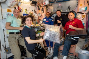 iss060e080763 (Sept. 26, 2019) --- Four Expedition 60 crewmembers and a spaceflight participant gather inside the Unity module for a meal. Pictured from left are, astronauts Luca Parmitano of ESA (European Space Agency) and Christina Koch of NASA, spaceflight participant and United Arab Emirates astronaut Hazzaa Ali Almansoori and NASA astronauts Andrew Morgan and Nick Hague.