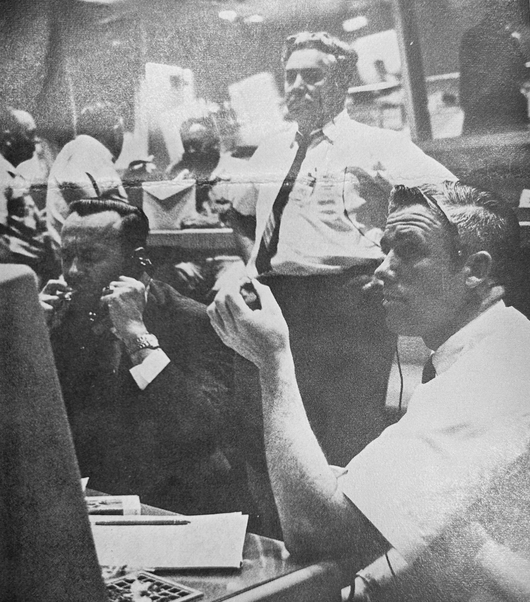 In the MCC, Flight Directors Christopher C. Kraft, left, and John D. Hodge, monitor the Gemini 1 mission