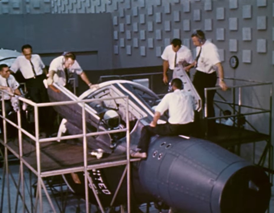 Workers at the McDonnell plant in St. Louis examine a Gemini spacecraft mockup
