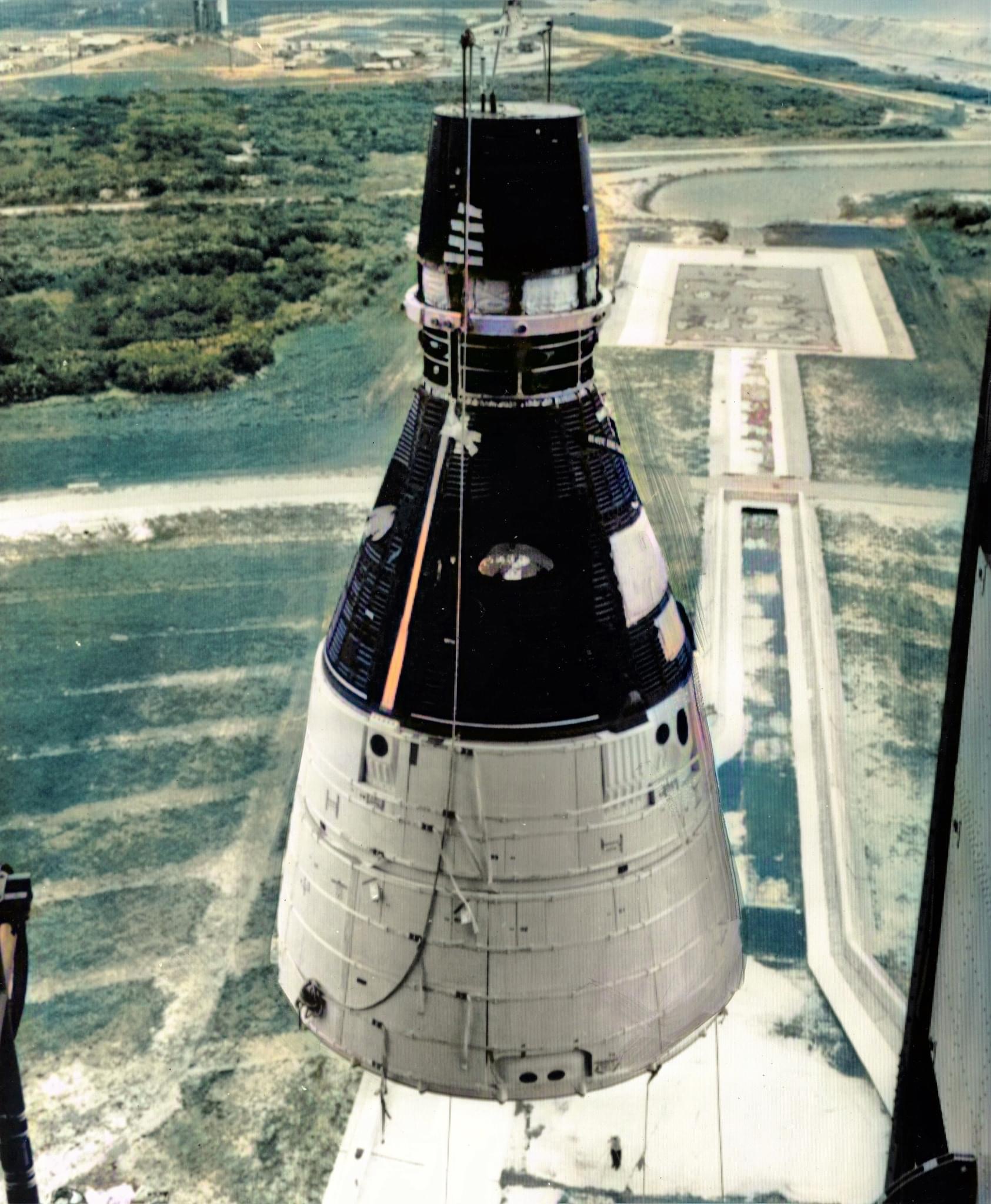 Workers lift Gemini 1 to mate it with its Titan II rocket