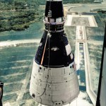 Workers lift Gemini 1 to mate it with its Titan II rocket