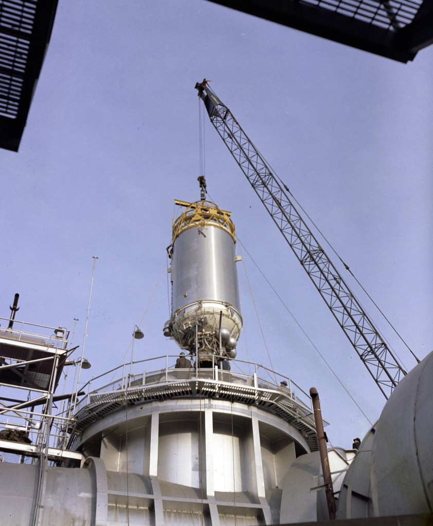 Rocket stage lowered into chamber.