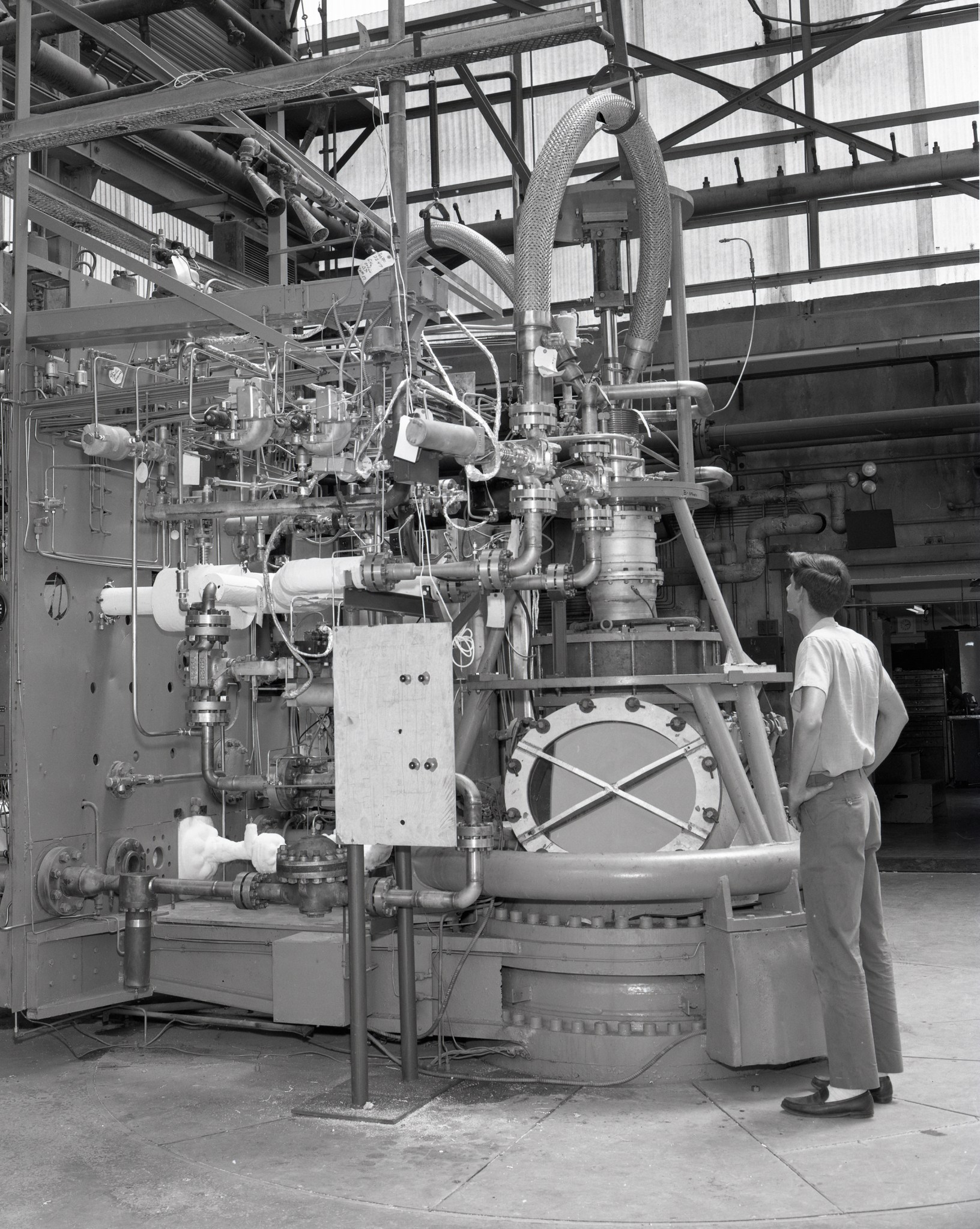 Man looking at rocket test stand.