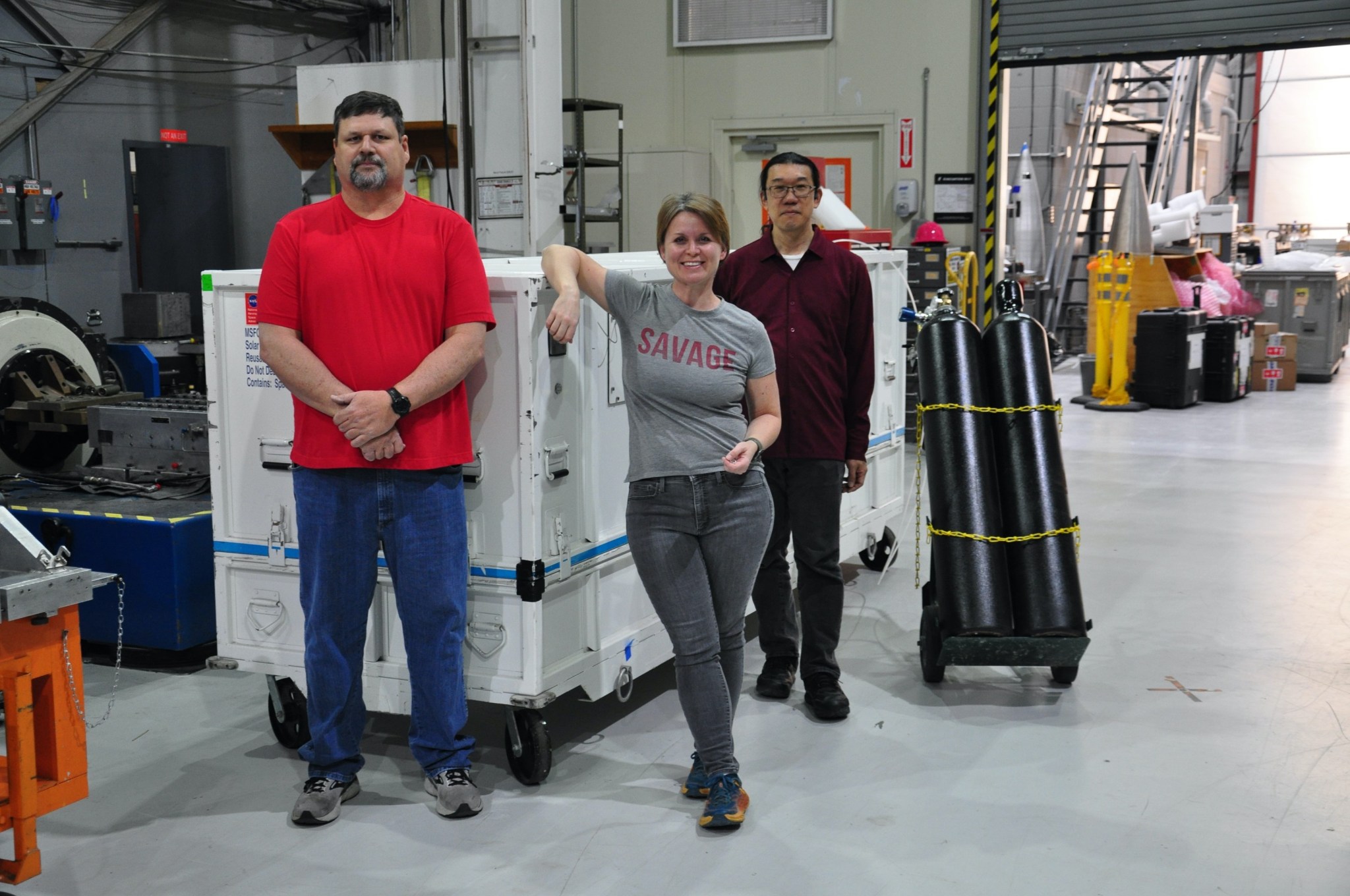 From left, NASA test engineer William Hogue, Hi-C principal investigator Sabrina Savage, and NASA systems scientist Ken Kobayashi stand in front of the Hi-C flare instrument section after it has been packaged and prepared for shipping from White Sands to Alaska.