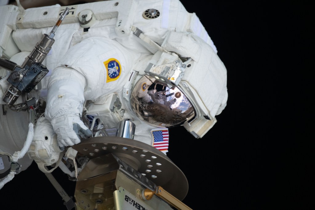 Expedition 70 Flight Engineer and NASA astronaut Loral O'Hara is pictured during a spacewalk for maintenance on the International Space Station's port solar alpha rotary joint, which allows the solar arrays to track the Sun and generate electricity to power the orbital outpost.