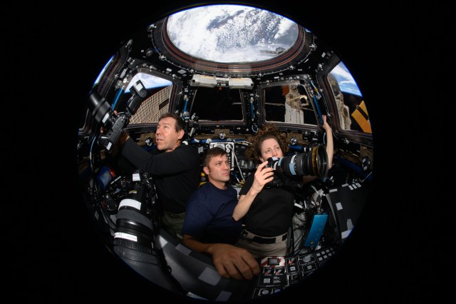 Expedition 70 Flight Engineers (from left) Mike Barratt, Matthew Dominick, and Loral O'Hara participate in an Earth photography session inside the cupola, the International Space Station's "window to the world." The orbital complex was soaring 259 miles above West Virginia in the United States at the time of this photograph.